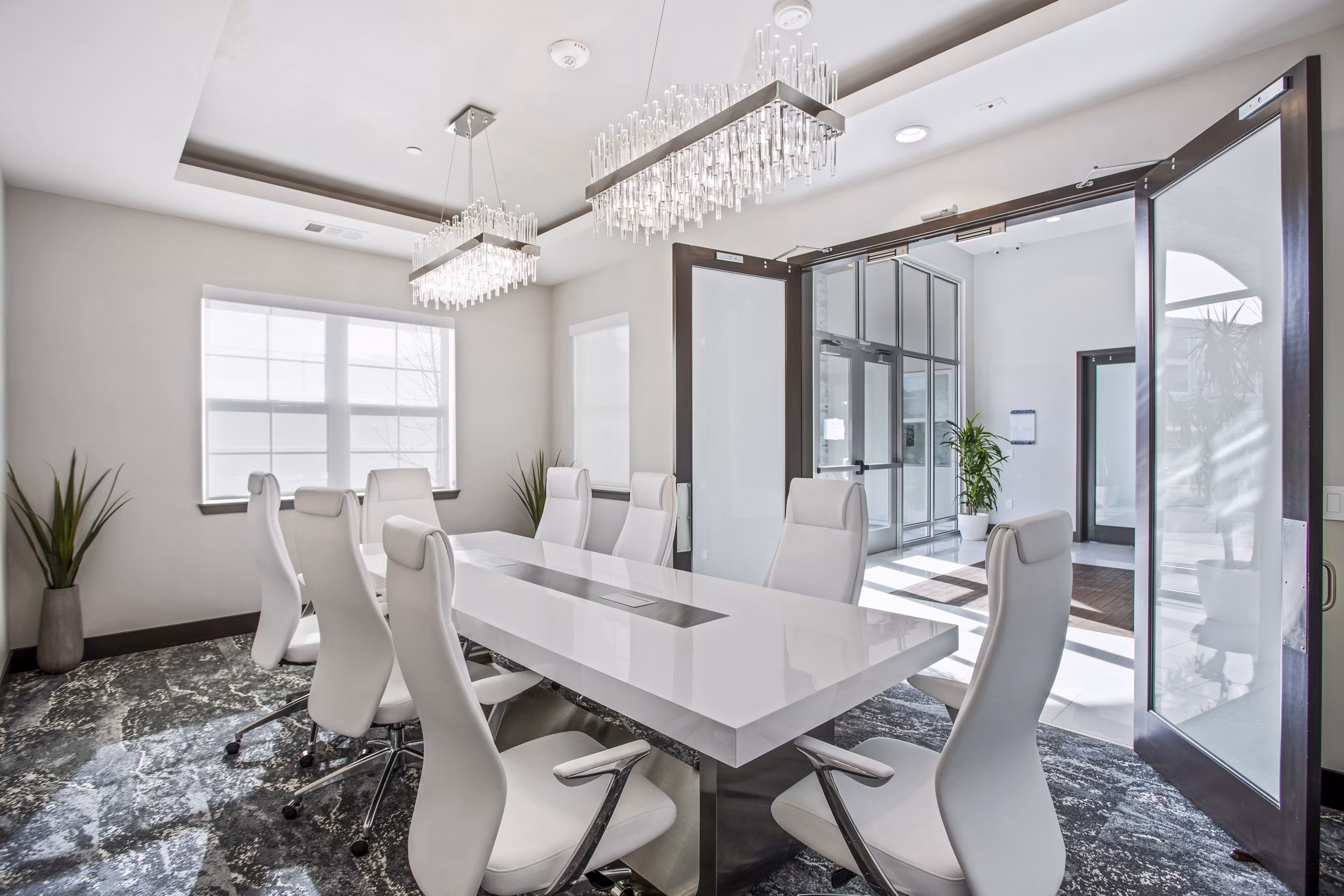 Clubhouse meeting facility with modern seating and presentation equipment at Inova Apartments