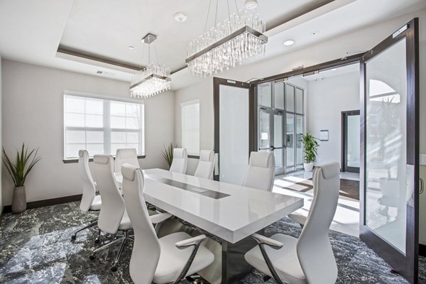 Clubhouse meeting facility with modern seating and presentation equipment at Inova Apartments