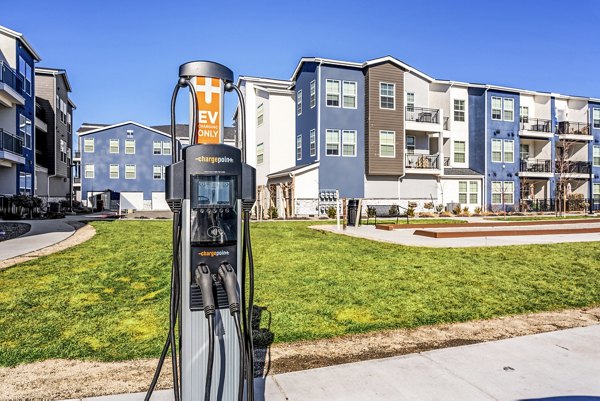 Electric vehicle charging station in Inova Apartments' parking lot, offering sustainability-focused amenities for residents