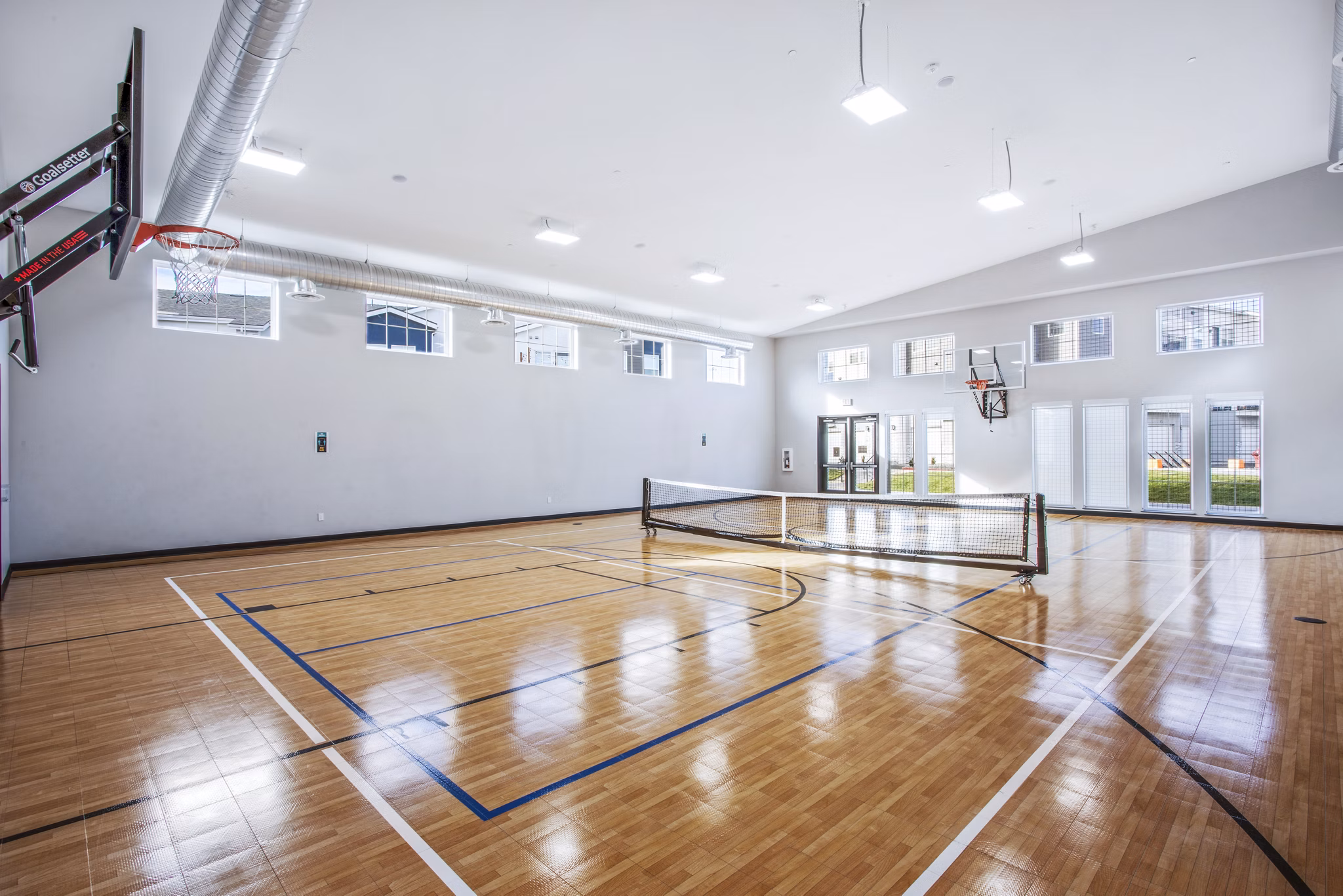 Indoor tennis court featuring high-quality surfaces at Inova Apartments