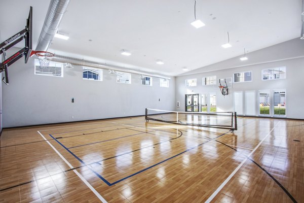 Indoor tennis court featuring high-quality surfaces at Inova Apartments