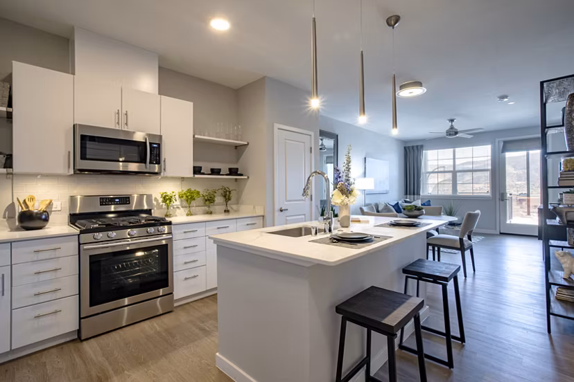 Modern kitchen featuring stainless steel appliances and granite countertops at Inova Apartments