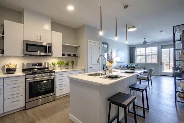 Modern kitchen featuring stainless steel appliances and granite countertops at Inova Apartments