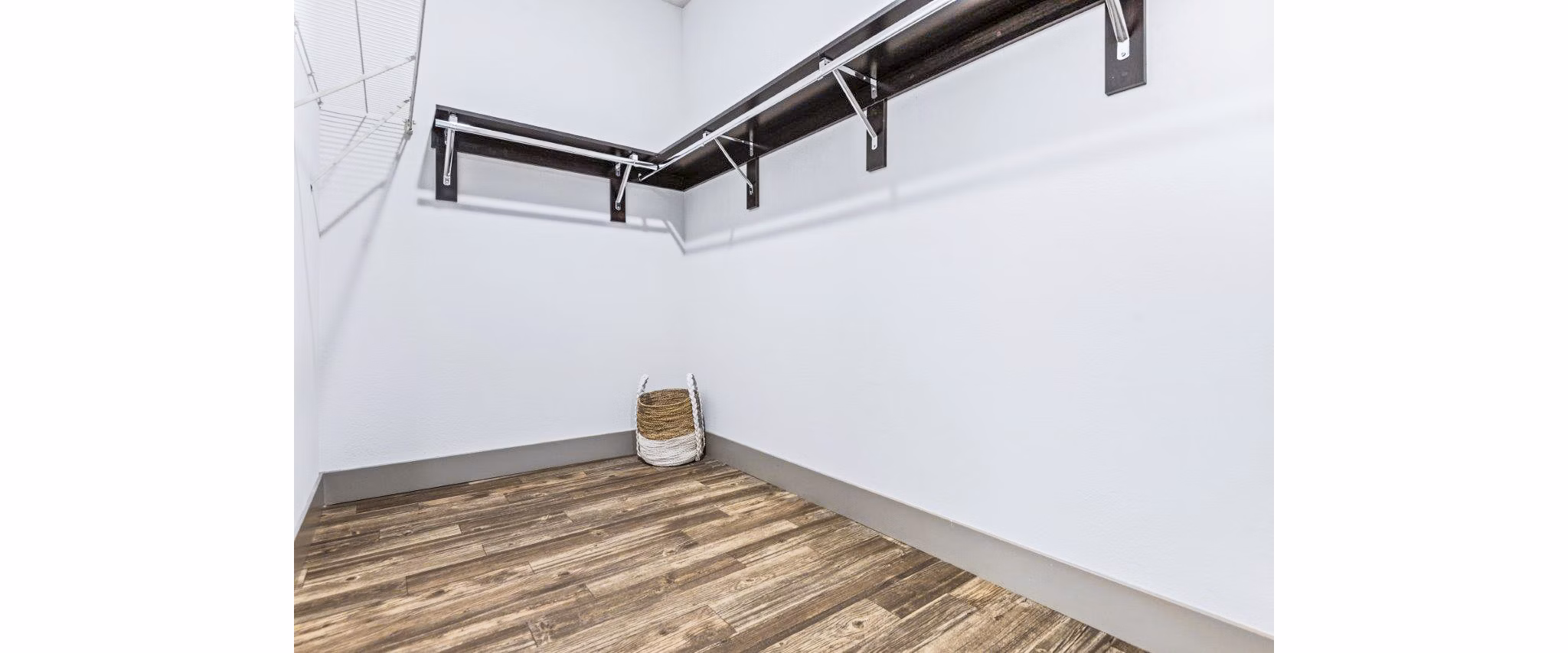 Organized bedroom closet featuring ample shelving at Reverb at Spring Valley Apartments