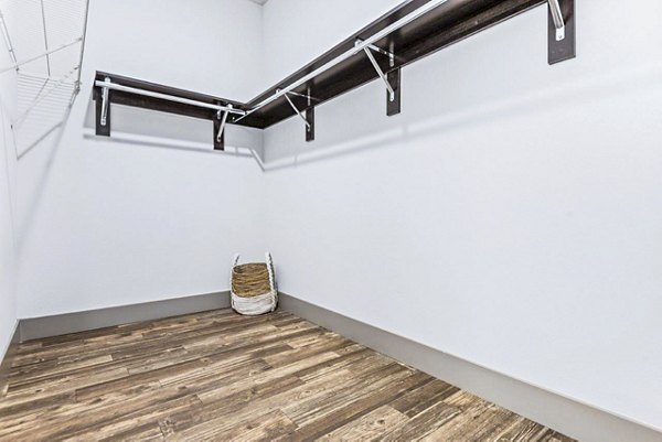 Organized bedroom closet featuring ample shelving at Reverb at Spring Valley Apartments