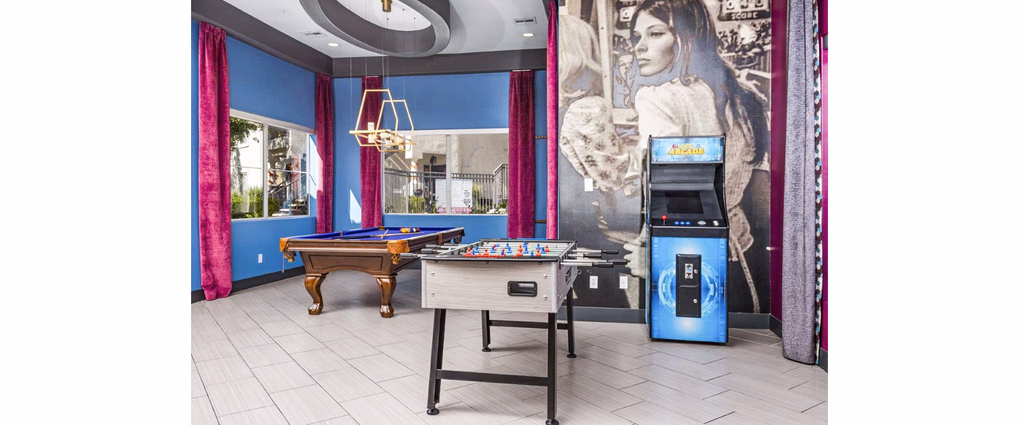 Clubhouse game room featuring pool table and modern seating at Reverb at Spring Valley Apartments