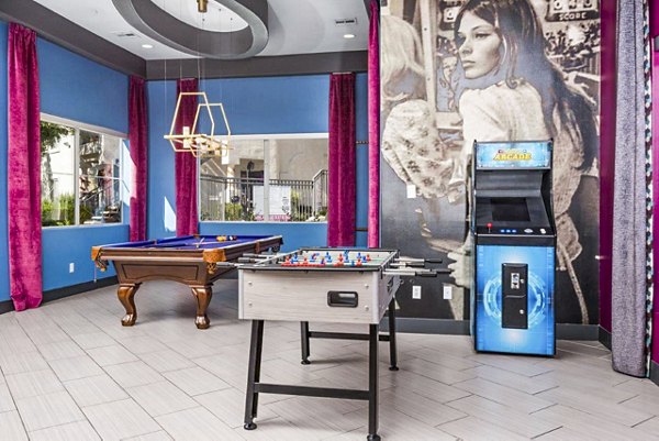 Clubhouse game room featuring pool table and modern seating at Reverb at Spring Valley Apartments