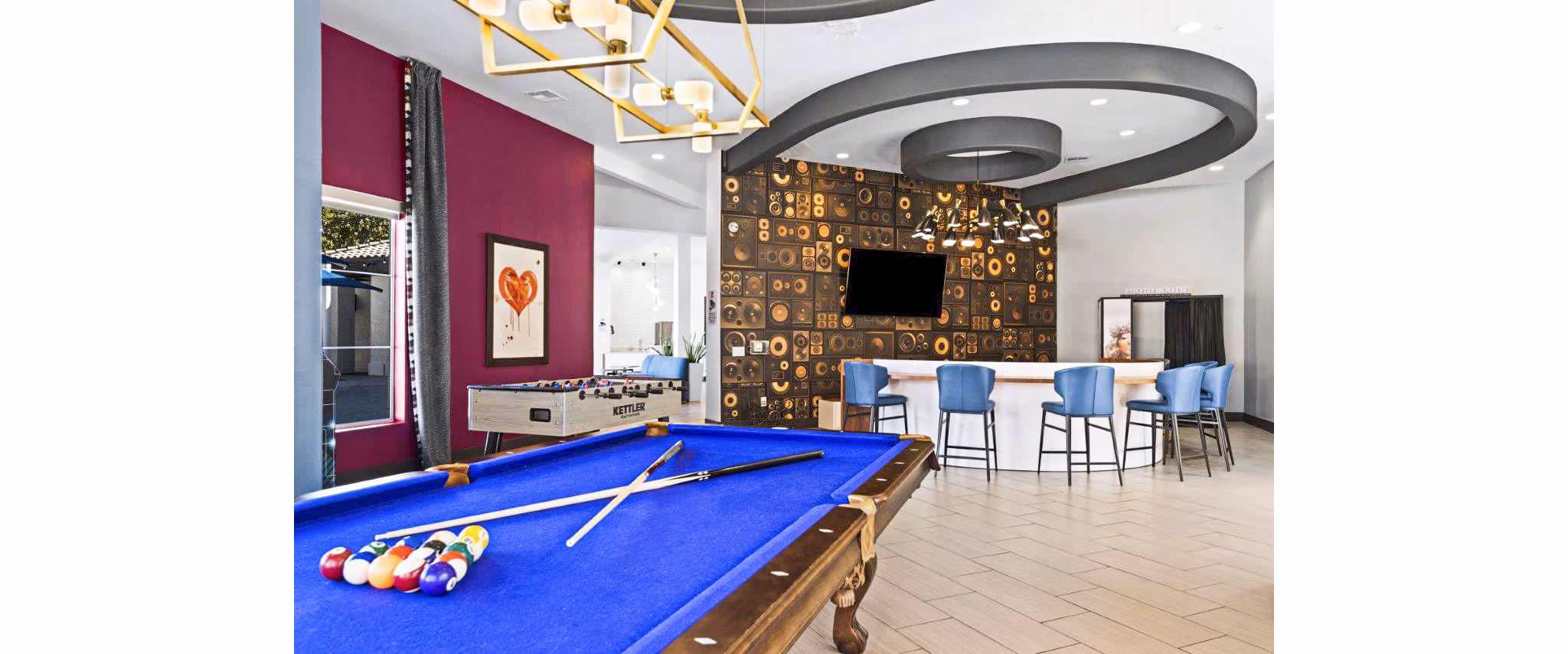 Clubhouse game room featuring billiards and lounge seating at Reverb at Spring Valley Apartments, a Greystar luxury apartment community