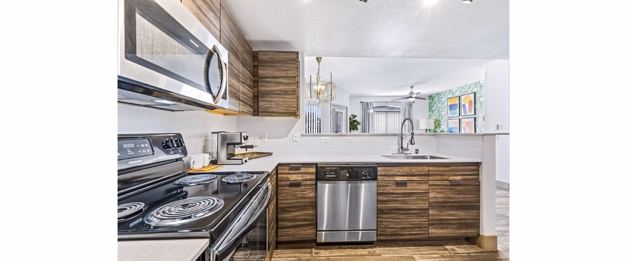 Modern kitchen with stainless steel appliances at Reverb at Spring Valley Apartments