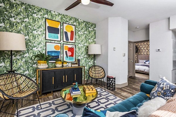 Modern living room featuring plush seating and large windows at Reverb at Spring Valley Apartments