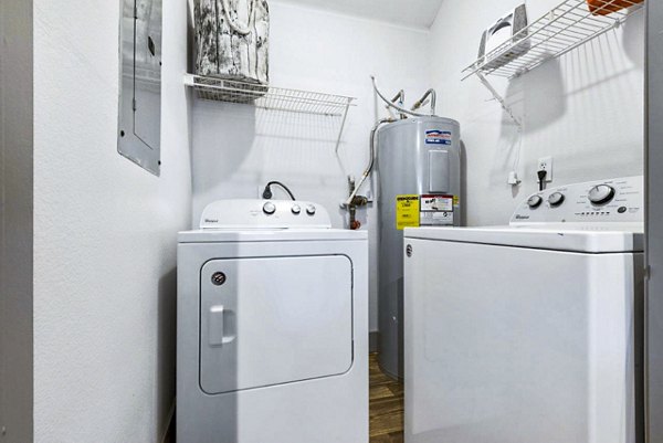 Laundry room with modern washers and dryers at Reverb at Spring Valley Apartments