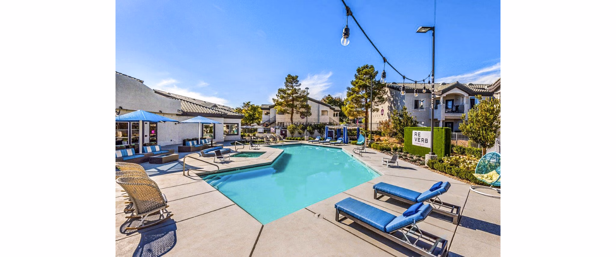 Modern pool area with sundeck at Reverb at Spring Valley Apartments, offering luxury amenities for relaxation and recreation