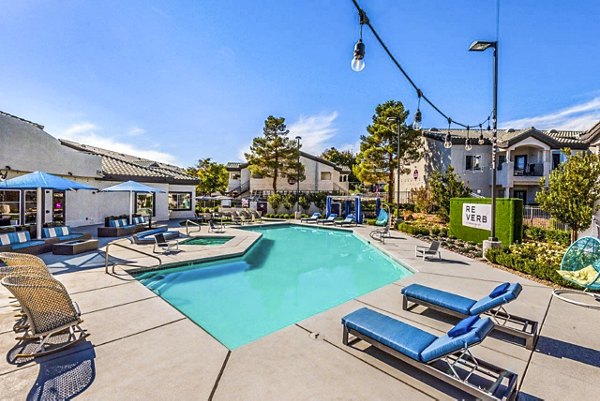 Modern pool area with sundeck at Reverb at Spring Valley Apartments, offering luxury amenities for relaxation and recreation