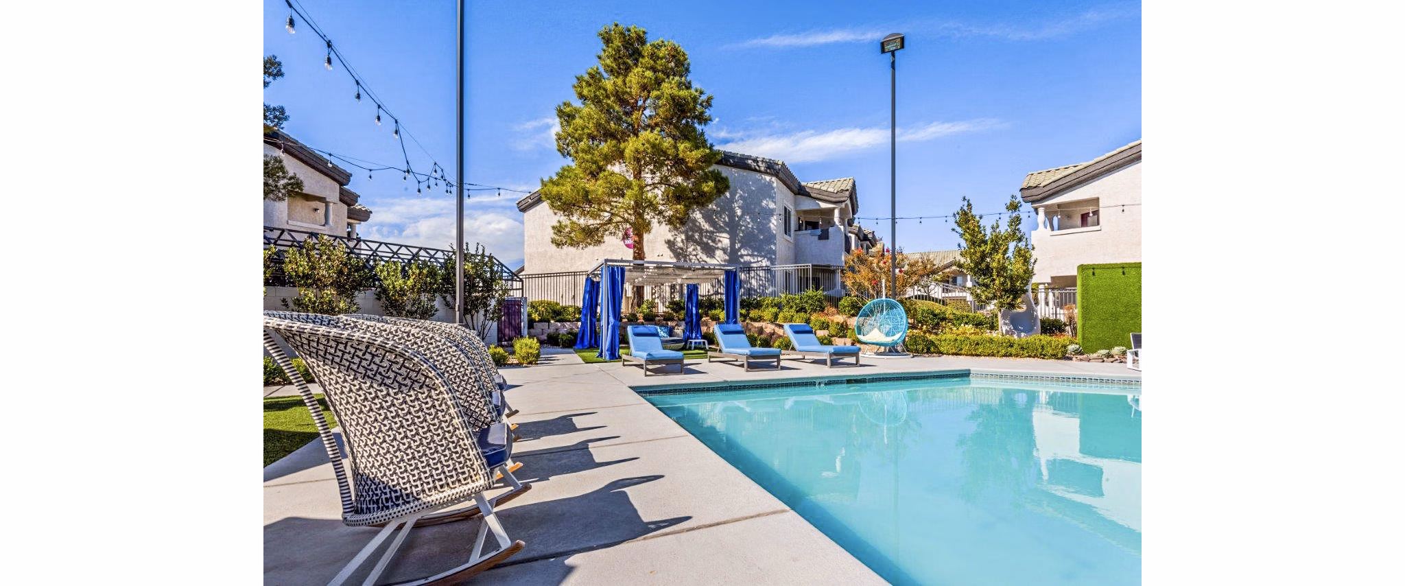 Reverb at Spring Valley: Modern pool with chic loungers and lush landscaping at luxury apartments