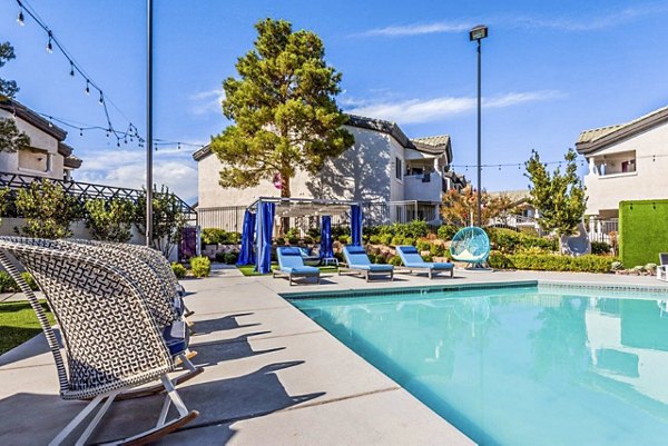 Reverb at Spring Valley: Modern pool with chic loungers and lush landscaping at luxury apartments