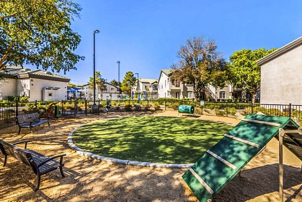 Green dog park with agility equipment at Reverb at Spring Valley Apartments