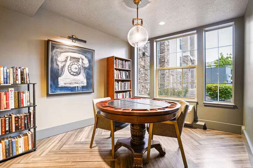 Game room and library with plush seating at The Ivy at Draper Apartments offering luxury entertainment and reading spaces