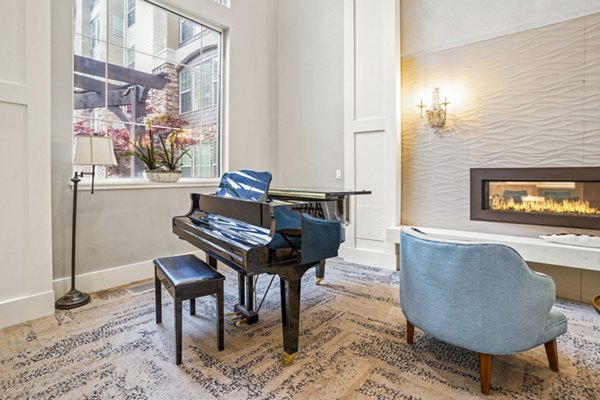 Clubhouse piano area with elegant seating at The Ivy at Draper Apartments, a luxury community offering refined social spaces for residents