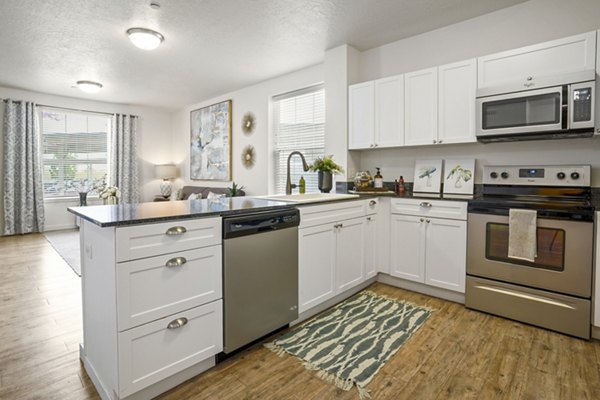 Kitchens with modern appliances at The Ivy at Draper Apartments