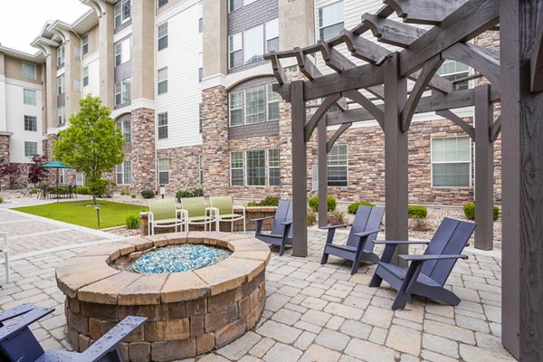 Inviting fire pit on a spacious patio at The Ivy at Draper Apartments, perfect for gatherings and relaxation in a luxury setting