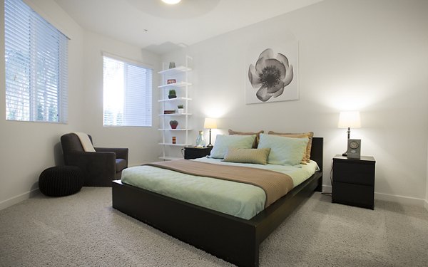 Eton at Warner Center: Cozy bedroom with modern decor and ample natural light in luxury apartments