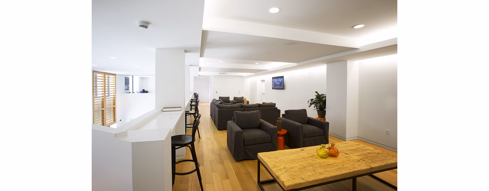 Eton at Warner Center: Modern clubhouse with communal seating areas and large windows, ideal for luxury living in Warner Center