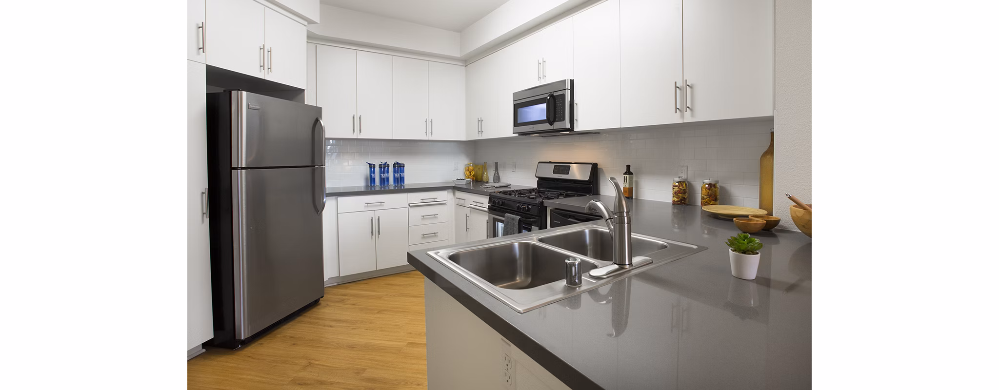 Eton at Warner Center: Modern kitchen with stainless steel appliances and granite countertops in luxury apartments