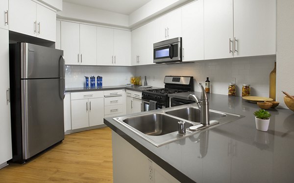 Eton at Warner Center: Modern kitchen with stainless steel appliances and granite countertops in luxury apartments