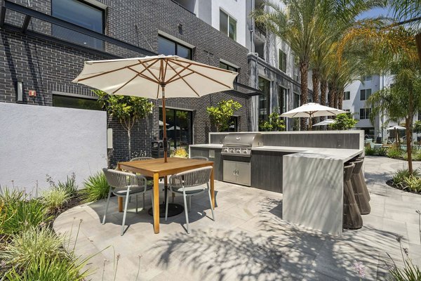 Eton at Warner Center: Cozy patio with seating and lush plants for relaxation at luxury apartments in Los Angeles