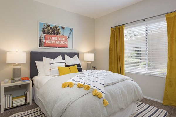Bedroom with plush bed and contemporary decor at Adobe Ridge Apartments, luxury living by Greystar