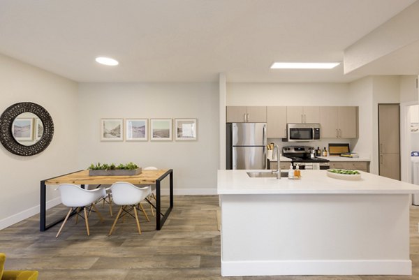 Dining area with modern decor at Adobe Ridge Apartments, featuring stylish furniture and open layout for luxury living