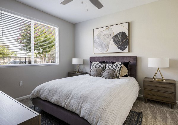 Cozy bedroom with elegant furnishings at Canyon Park Apartments, featuring ample natural light and luxurious design elements