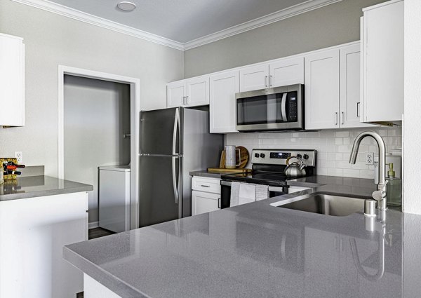 Spacious kitchen with modern appliances and sleek countertops in Canyon Park Apartments