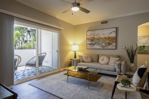 Spacious living room with modern decor in Canyon Park Apartments, featuring comfortable seating and ample natural light