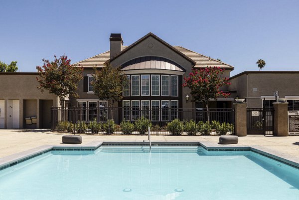 Resort-style pool with lounge chairs at Canyon Park Apartments