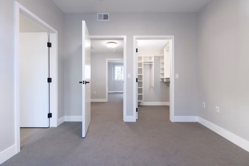 Inviting bedroom with modern furnishings and large window at 599 Castro Apartments