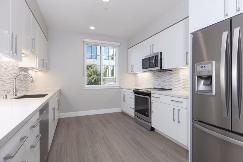Modern kitchen with sleek countertops and stainless steel appliances at 599 Castro Apartments luxury community