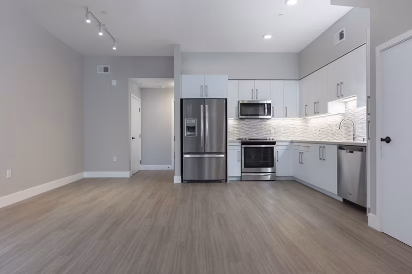 Modern kitchen with sleek appliances and marble countertops in 599 Castro Apartments, luxury living near downtown