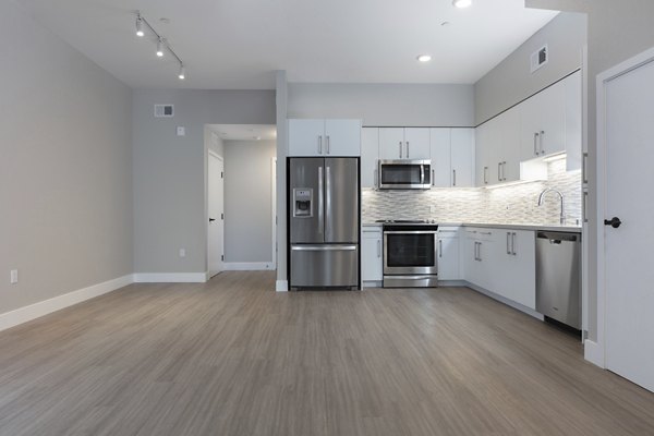 Modern kitchen with sleek appliances and marble countertops in 599 Castro Apartments, luxury living near downtown
