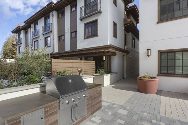 Grill area with seating and gas grills at 599 Castro Apartments
