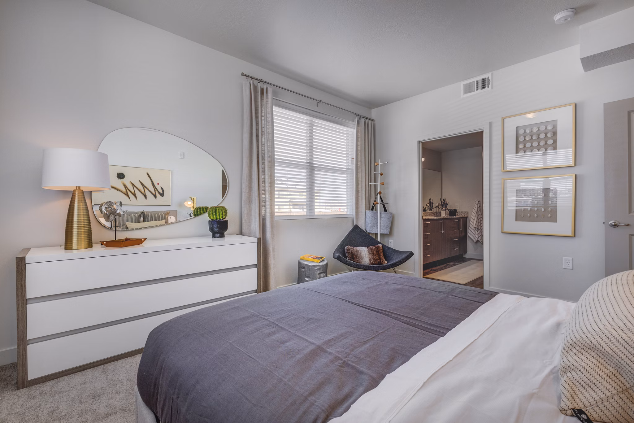 Modern bedroom with elegant design and large windows in Aspira at Anthem Apartments