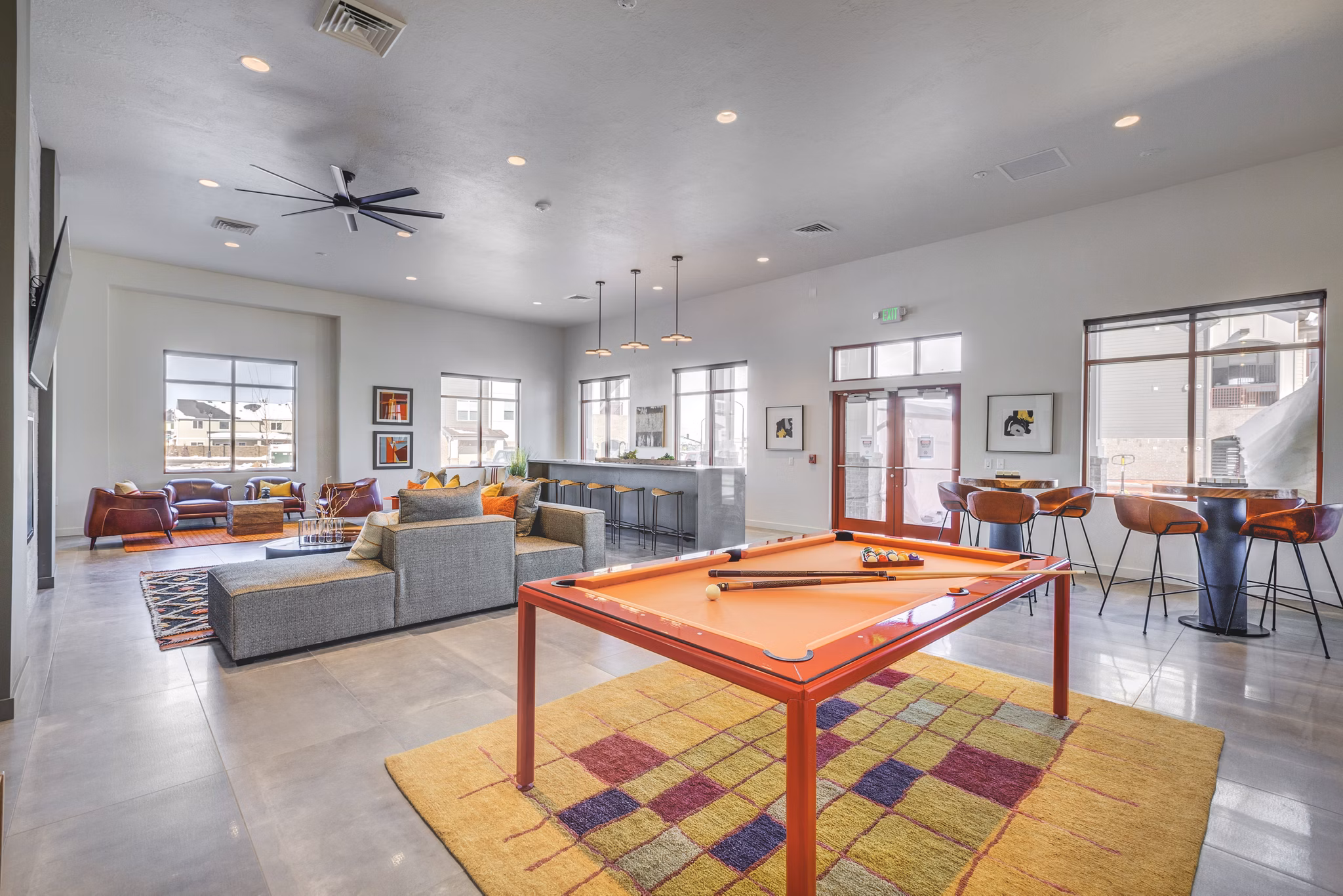 Game room with pool table and modern seating at Aspira at Anthem Apartments, perfect for entertainment and relaxation