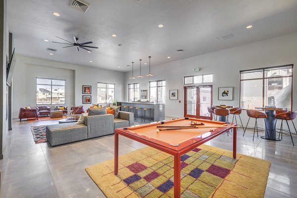 Game room with pool table and modern seating at Aspira at Anthem Apartments, perfect for entertainment and relaxation
