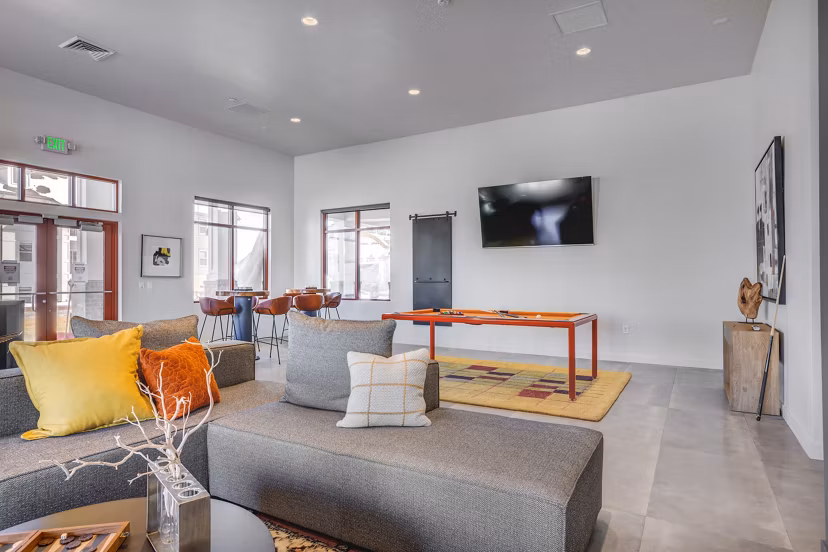 Clubhouse featuring modern seating and entertainment spaces at Aspira at Anthem Apartments