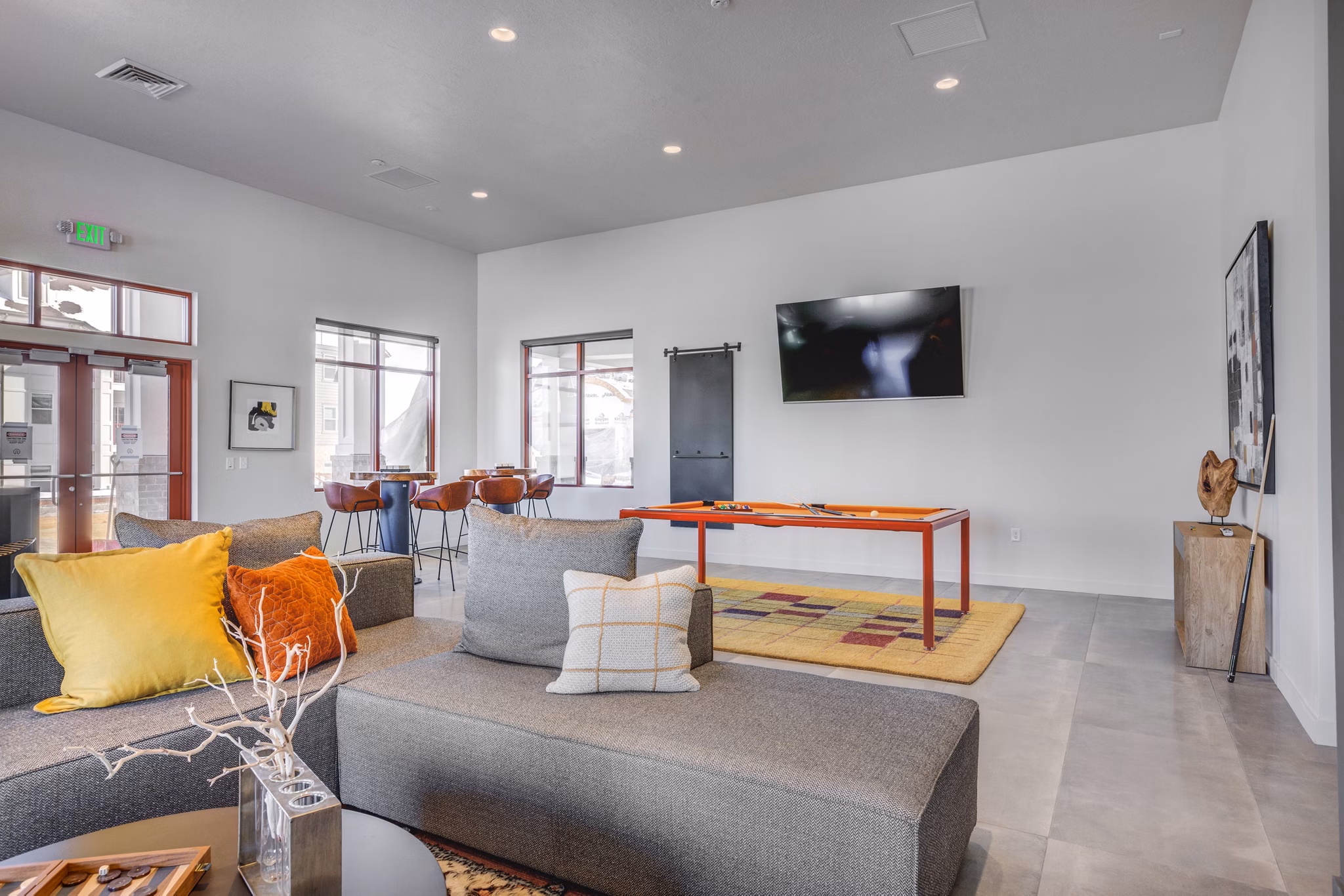 Clubhouse featuring modern seating and entertainment spaces at Aspira at Anthem Apartments