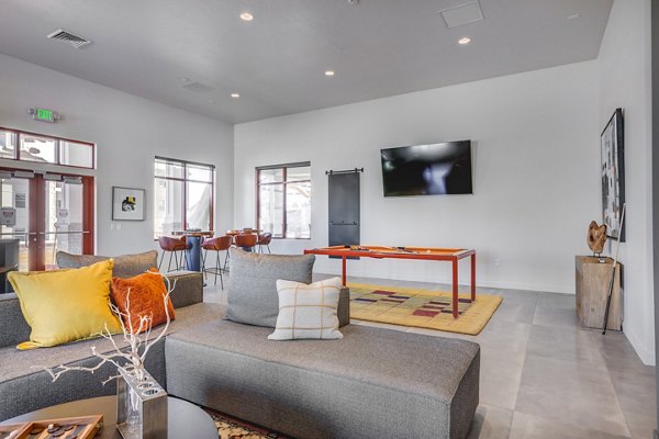 Clubhouse featuring modern seating and entertainment spaces at Aspira at Anthem Apartments