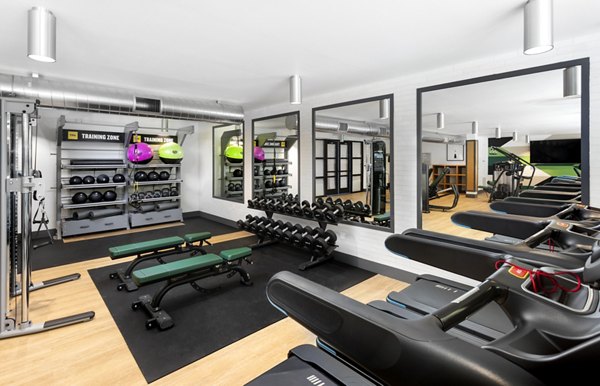 State-of-the-art fitness center with modern equipment at 7403 Apartments, offering luxury amenities for residents