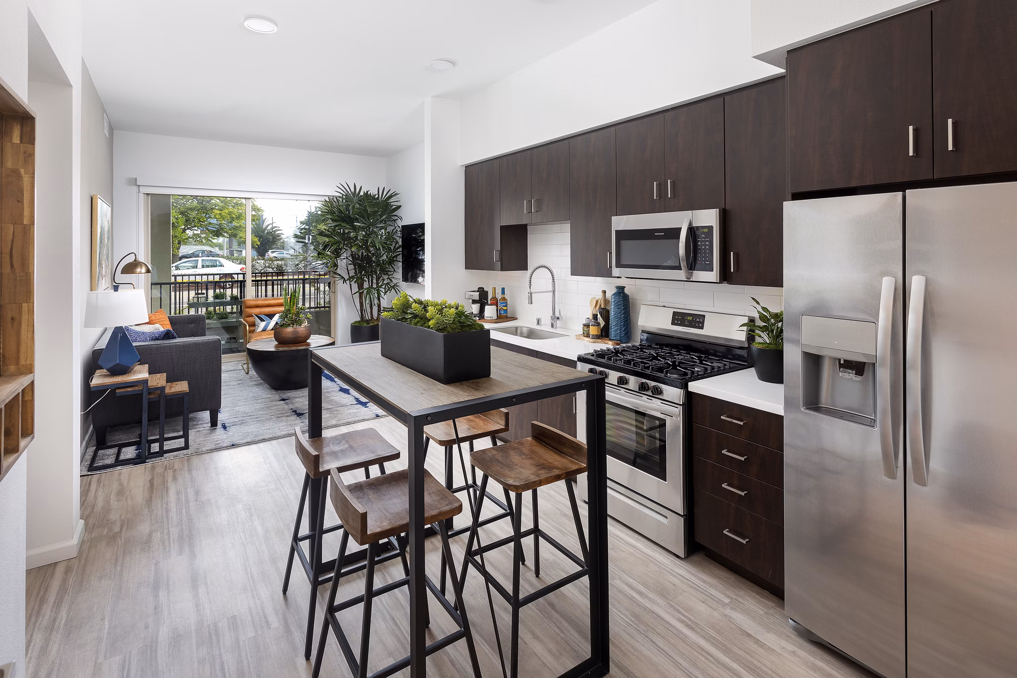 Modern kitchen with granite countertops and stainless steel appliances at 7403 Apartments