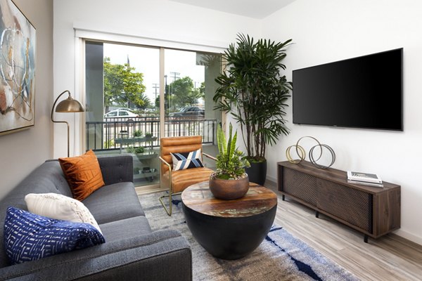 Modern living room with elegant design at 7403 Apartments, featuring plush seating and stylish decor