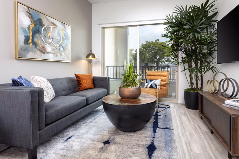 Cozy living room with modern decor and ample natural light at 7403 Apartments, perfect for relaxation or entertaining guests
